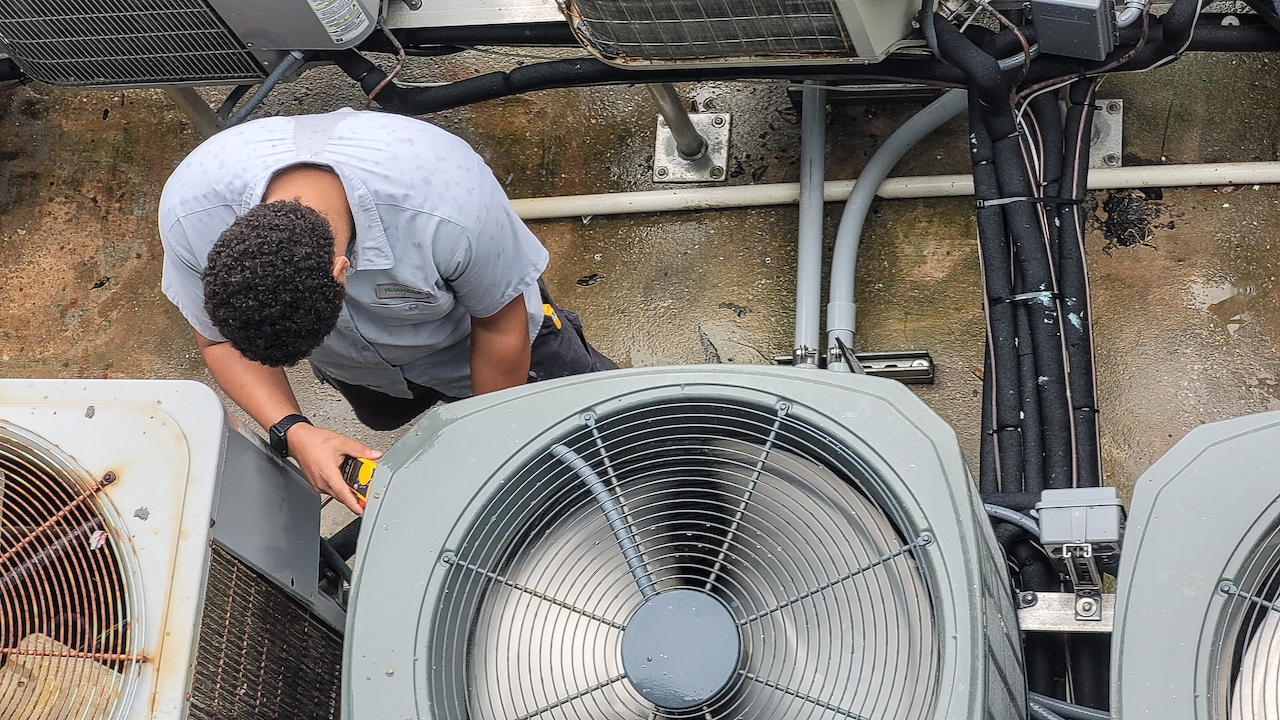 heating and cooling repair service technician working on HVAC system
